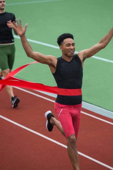 Handsome african athlete man crossing finish line Handsome african athlete man crossing finish line