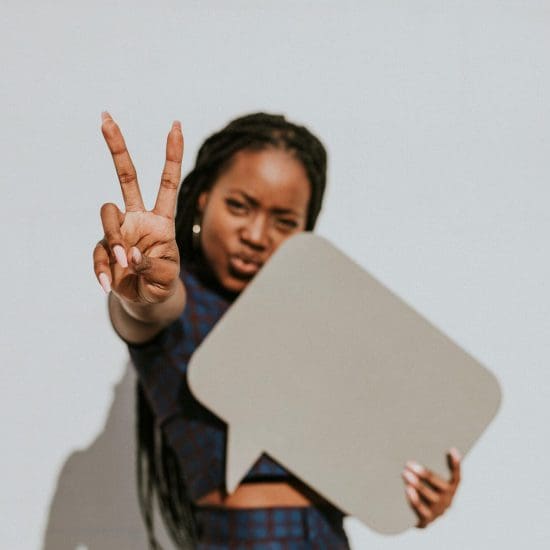 Woman doing a peace sign Woman doing a peace sign